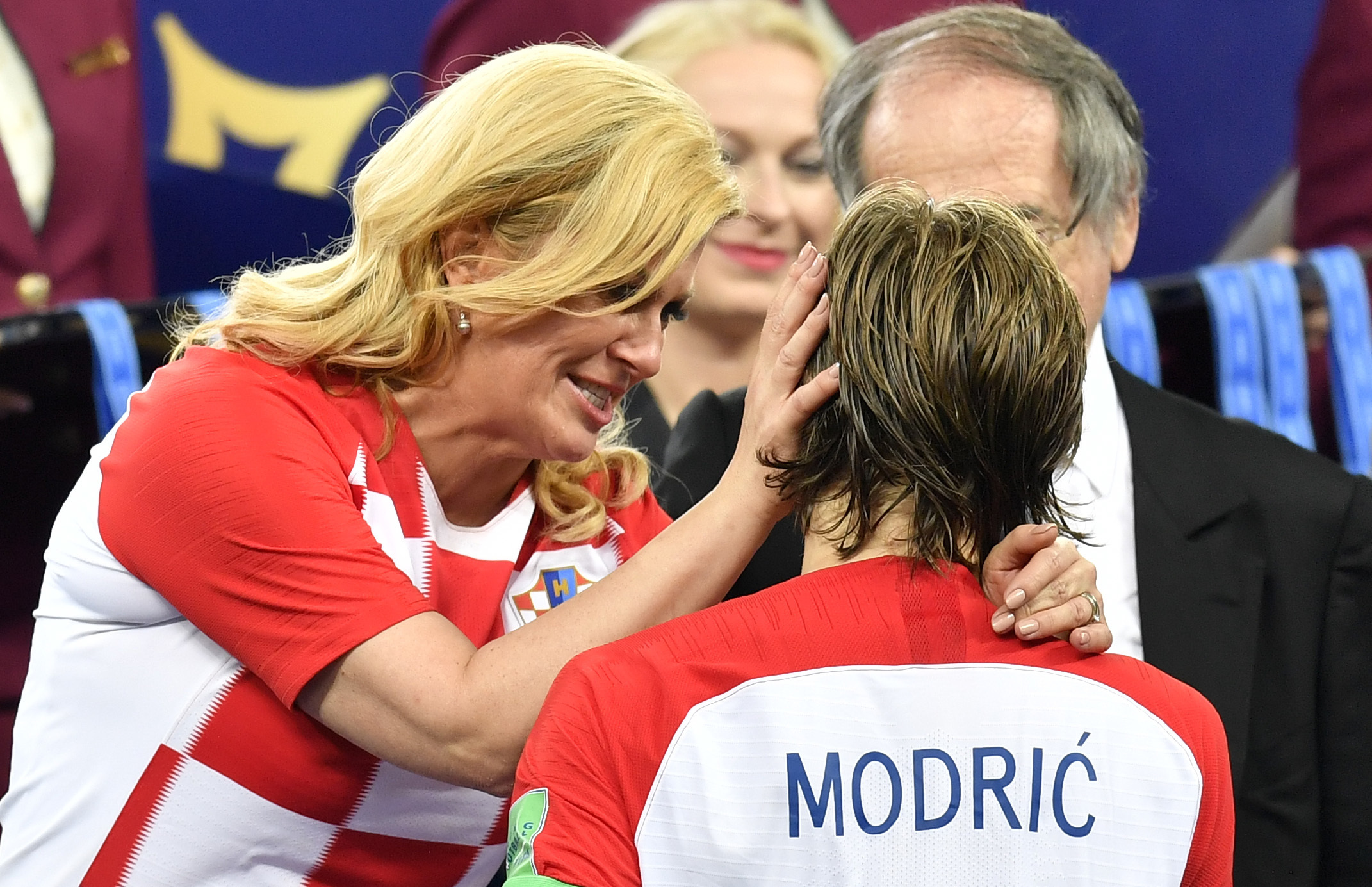 Croatian President Kolinda Grabar-Kitarovic hugs Croatia's Luka Modric after France won the final match between France and Croatia at the 2018 soccer World Cup in the Luzhniki Stadium in Moscow - AP